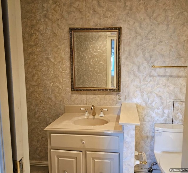 bathroom featuring vanity and toilet