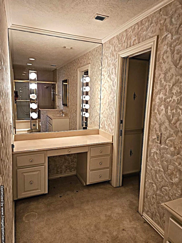 bathroom featuring vanity, a textured ceiling, and ornamental molding