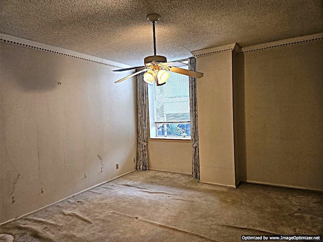 carpeted spare room with a textured ceiling and ceiling fan