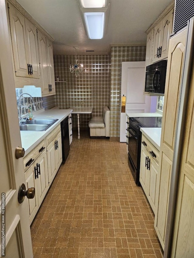 kitchen featuring tasteful backsplash, sink, black appliances, decorative light fixtures, and an inviting chandelier