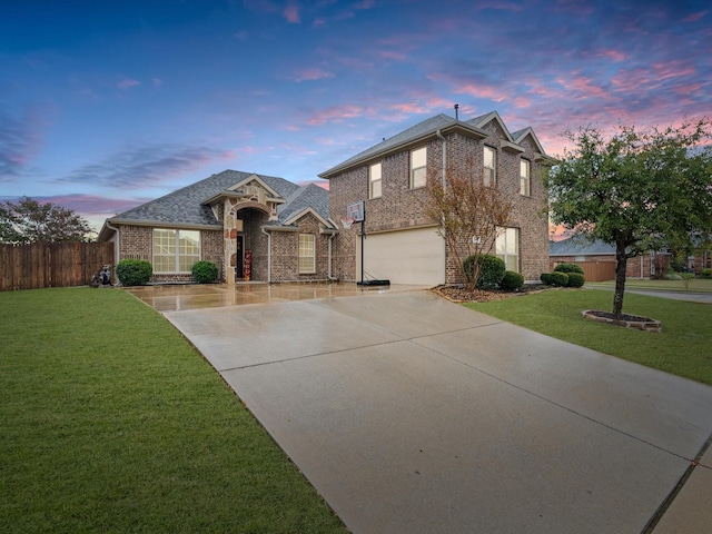 view of front of home with a garage and a yard