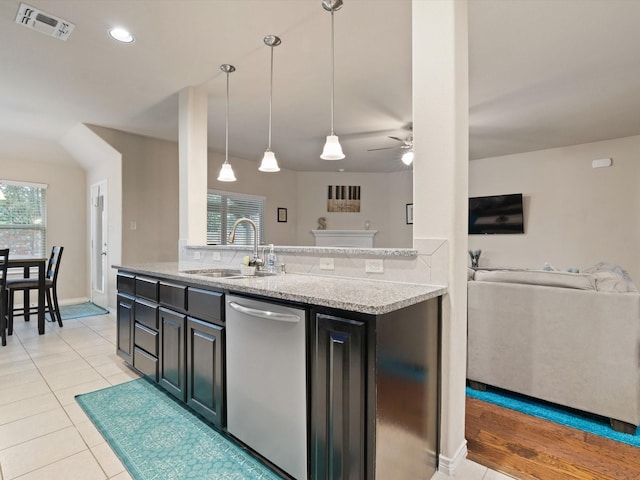 kitchen featuring ceiling fan, sink, hanging light fixtures, stainless steel dishwasher, and light tile patterned floors