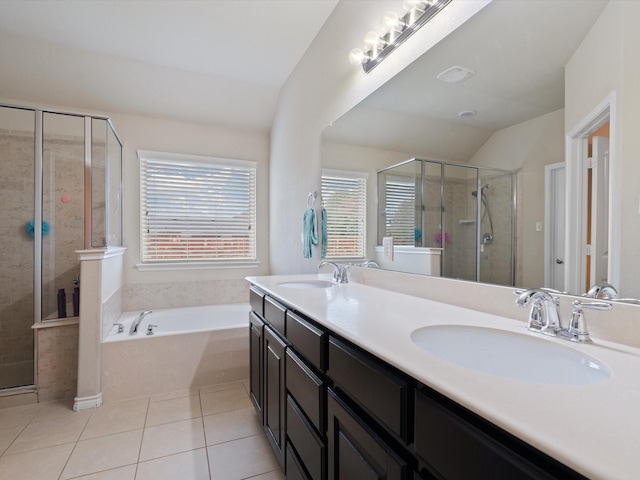 bathroom featuring tile patterned floors, a healthy amount of sunlight, separate shower and tub, and vaulted ceiling