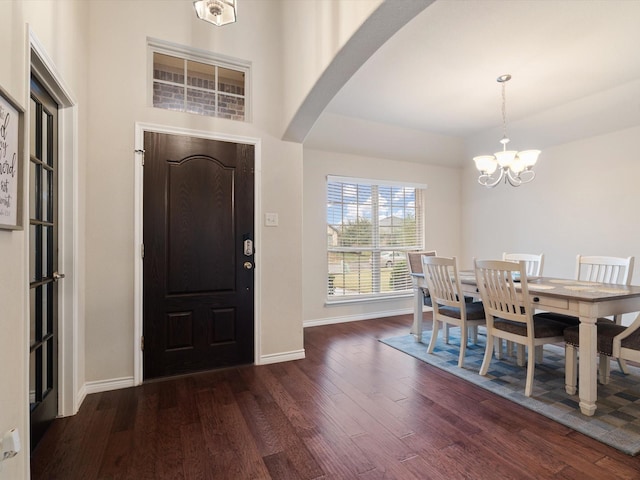 foyer entrance with a chandelier and dark hardwood / wood-style floors