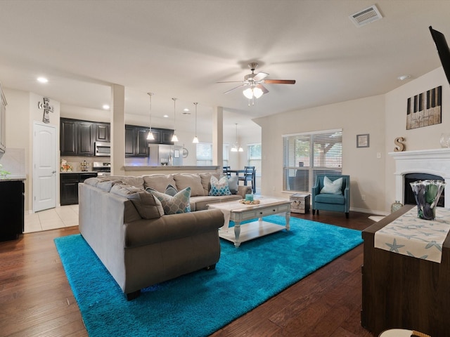 living room featuring ceiling fan and light hardwood / wood-style flooring