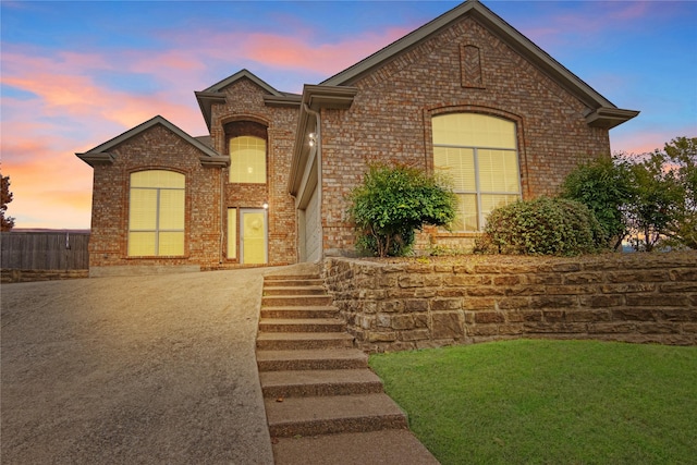 french provincial home featuring a lawn