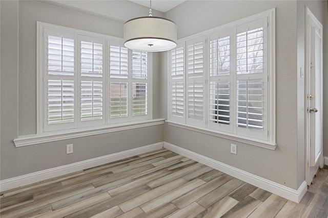 unfurnished dining area featuring light hardwood / wood-style floors