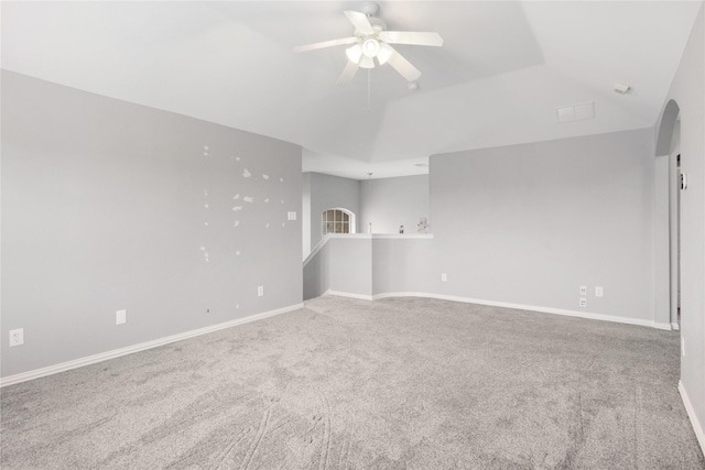 spare room featuring vaulted ceiling, ceiling fan, and carpet