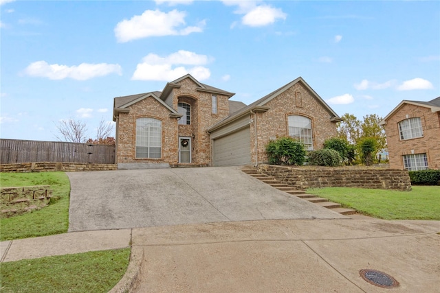 view of property with a garage and a front lawn