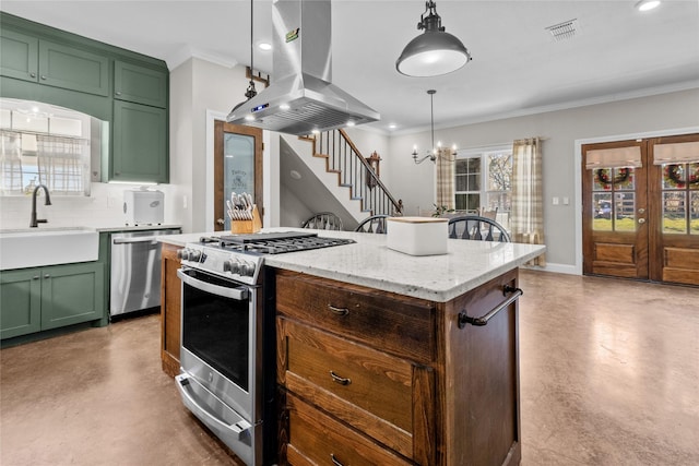 kitchen with sink, hanging light fixtures, tasteful backsplash, island exhaust hood, and appliances with stainless steel finishes