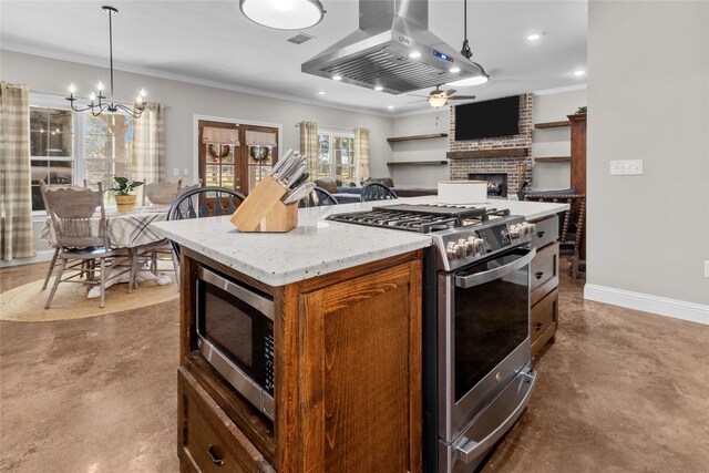 kitchen with a brick fireplace, decorative light fixtures, island range hood, a kitchen island, and appliances with stainless steel finishes