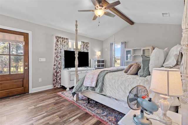 bedroom with hardwood / wood-style floors, lofted ceiling with beams, multiple windows, and ceiling fan