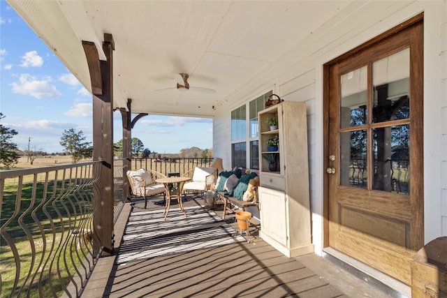 wooden terrace featuring ceiling fan