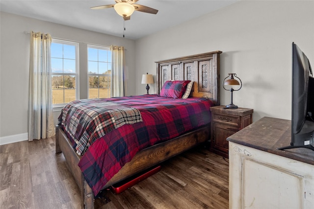 bedroom with ceiling fan and dark hardwood / wood-style floors