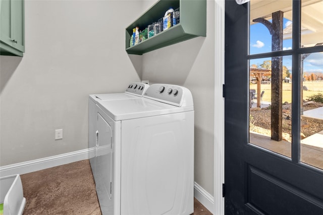 clothes washing area with cabinets and independent washer and dryer