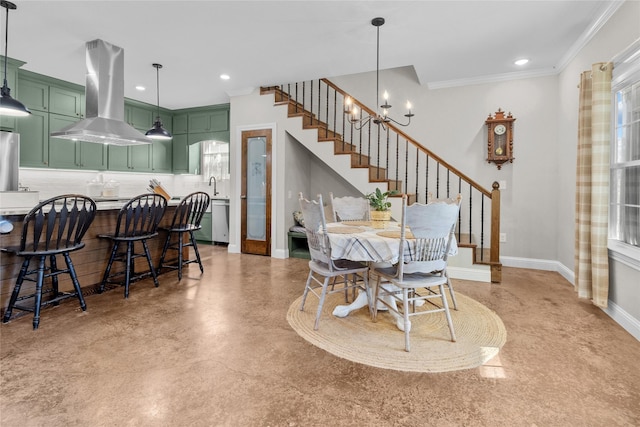 dining area with ornamental molding, sink, and a chandelier