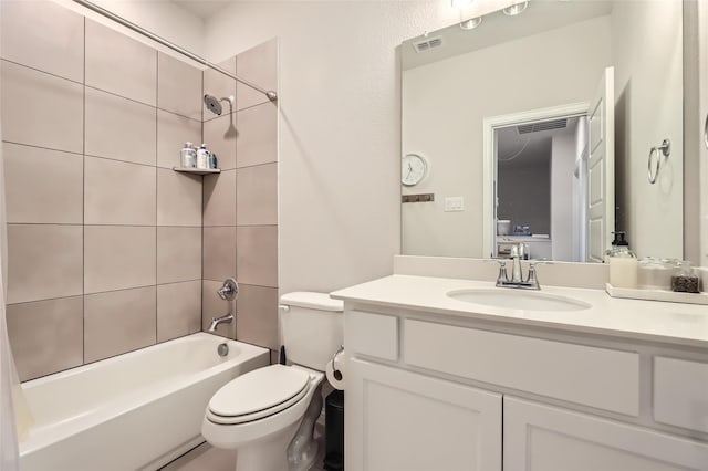 full bathroom with tiled shower / bath combo, toilet, and vanity