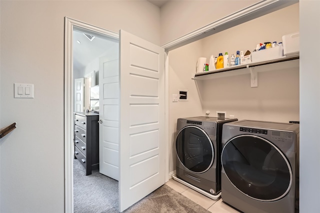 washroom with light carpet and washer and dryer