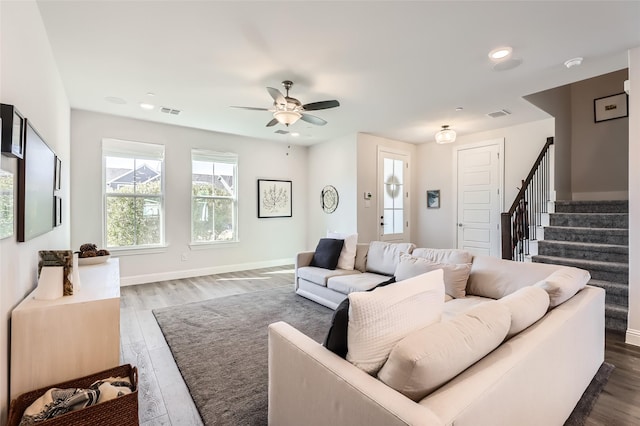 living room with dark hardwood / wood-style floors and ceiling fan