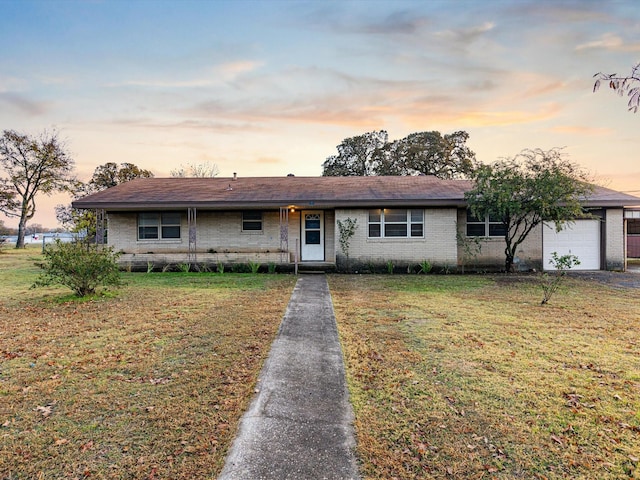 ranch-style home with a lawn and a garage