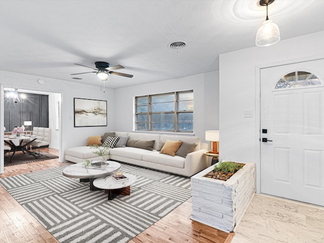 living room with ceiling fan and light hardwood / wood-style floors