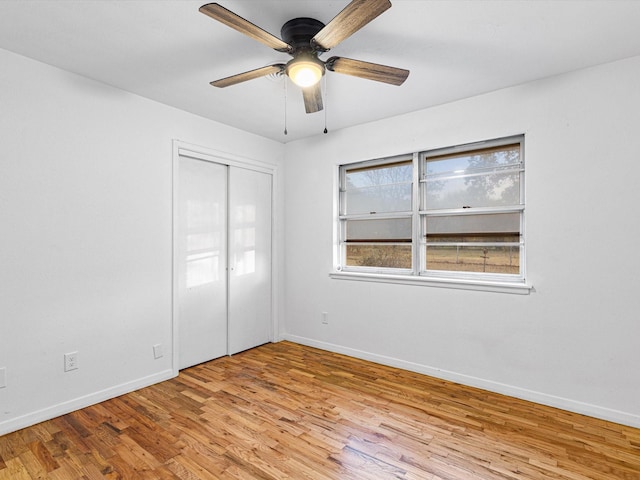 unfurnished bedroom with ceiling fan, a closet, and light hardwood / wood-style flooring