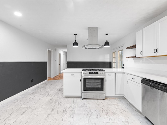 kitchen featuring white cabinets, hanging light fixtures, range hood, kitchen peninsula, and stainless steel appliances