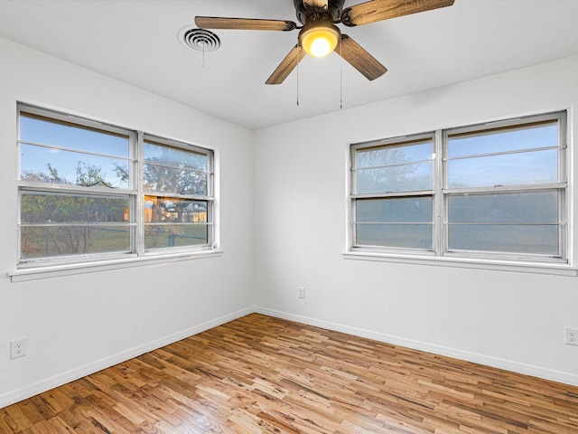 empty room featuring ceiling fan and light hardwood / wood-style flooring