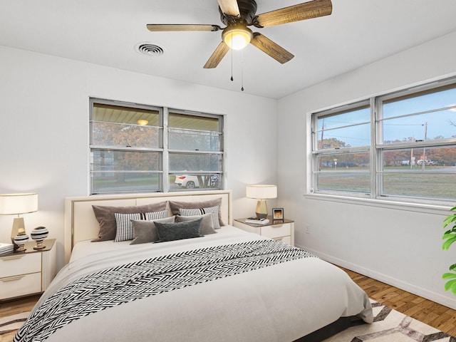 bedroom with ceiling fan and wood-type flooring