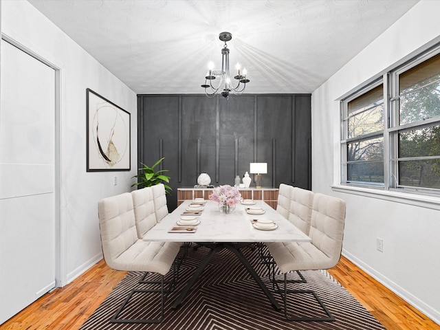 dining room with a notable chandelier and light hardwood / wood-style flooring