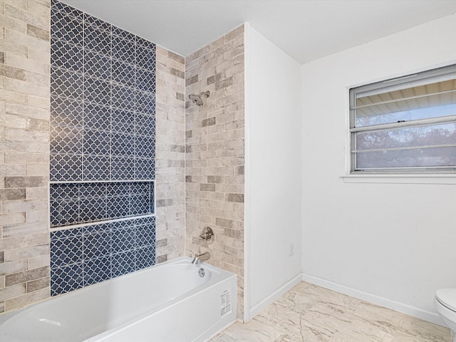 bathroom featuring toilet and tiled shower / bath