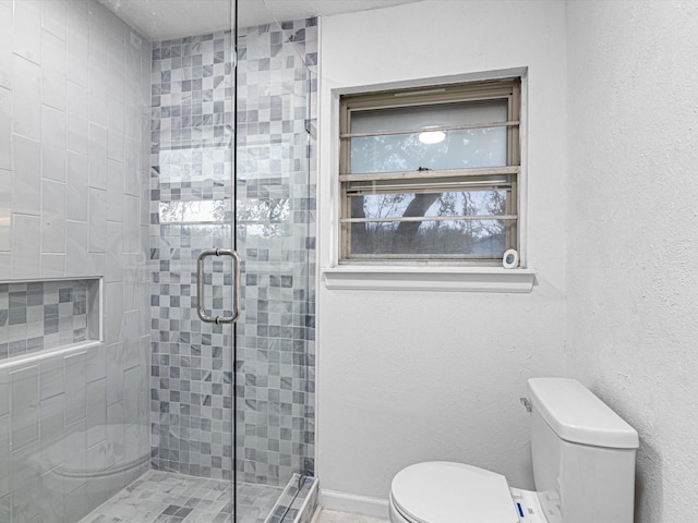 bathroom featuring walk in shower and toilet