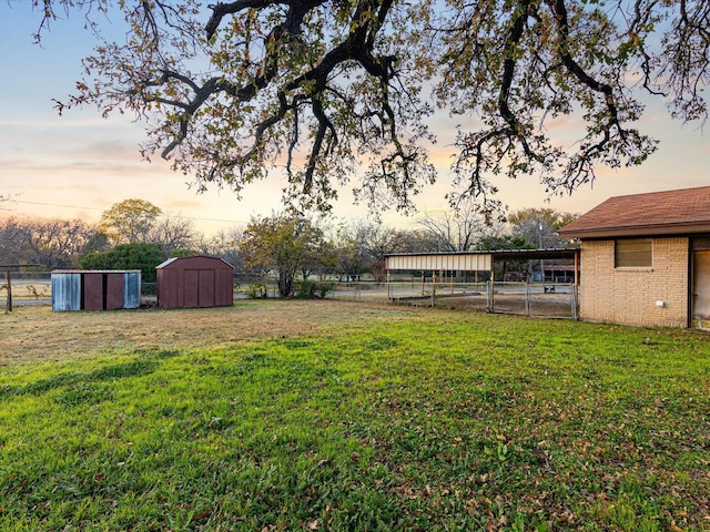 yard at dusk with a shed