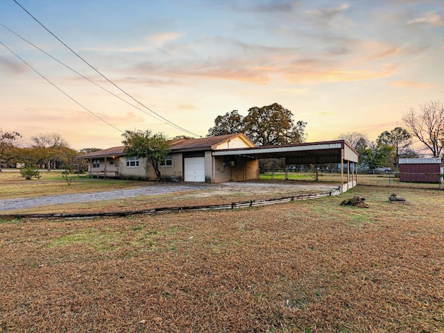 view of front facade with a carport and a lawn