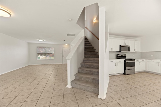 stairs featuring tile patterned flooring