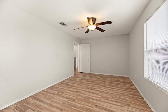 unfurnished room featuring ceiling fan, a healthy amount of sunlight, and light wood-type flooring