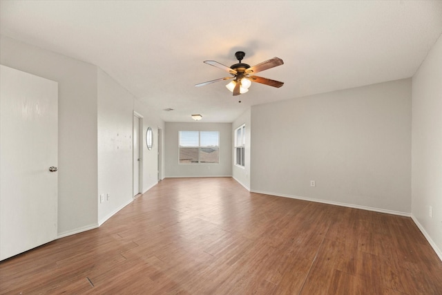 empty room featuring hardwood / wood-style floors and ceiling fan