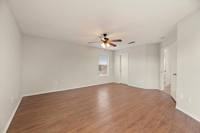 empty room featuring hardwood / wood-style flooring and ceiling fan