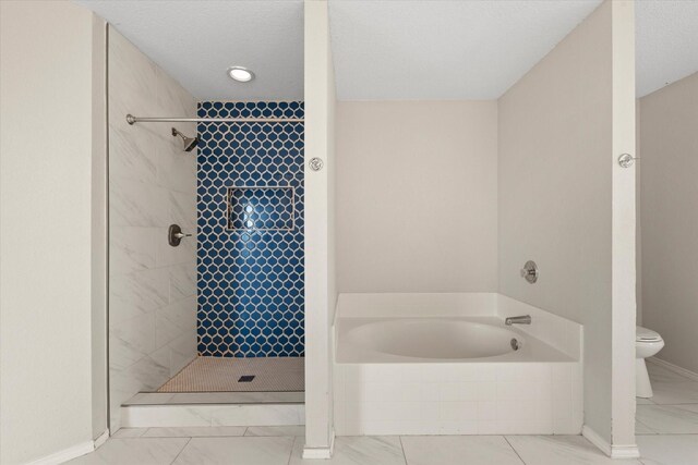 bathroom with plus walk in shower, a textured ceiling, and toilet