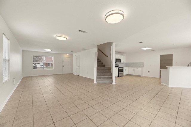 unfurnished living room featuring light tile patterned floors