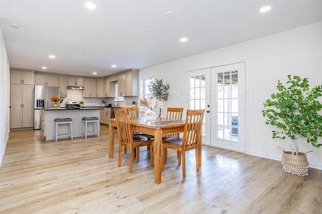 dining room featuring french doors and light hardwood / wood-style flooring