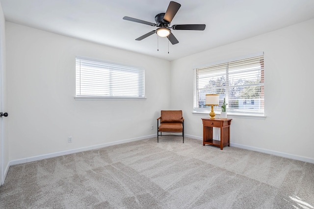 unfurnished room with light colored carpet and ceiling fan