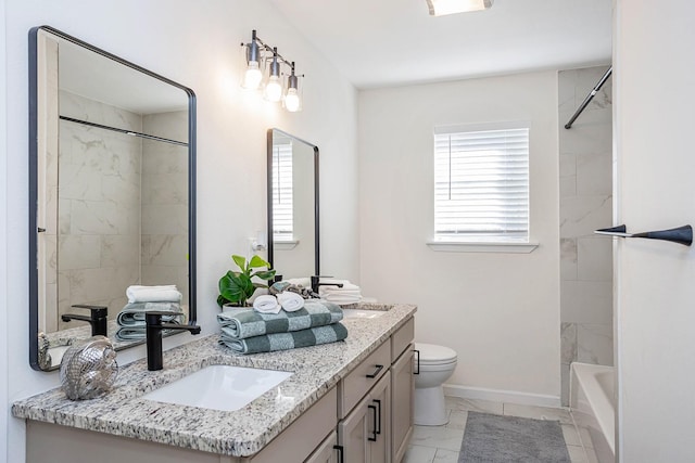 full bathroom with tiled shower / bath, vanity, and toilet