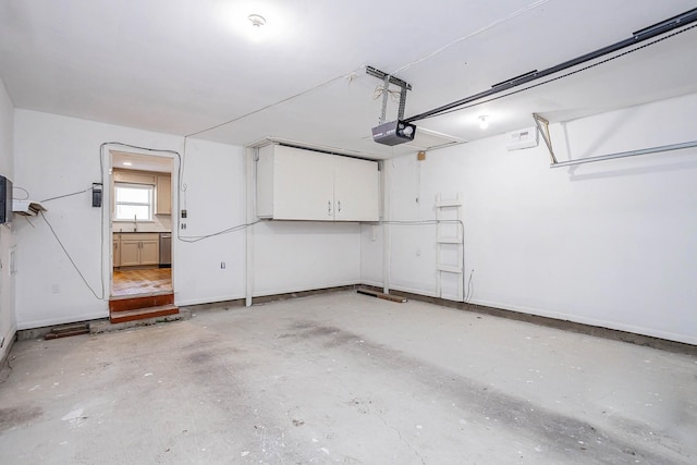 garage featuring sink and a garage door opener