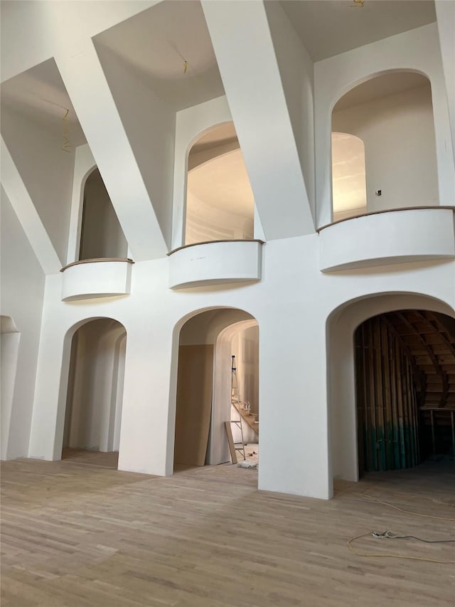 hall featuring a high ceiling and wood finished floors