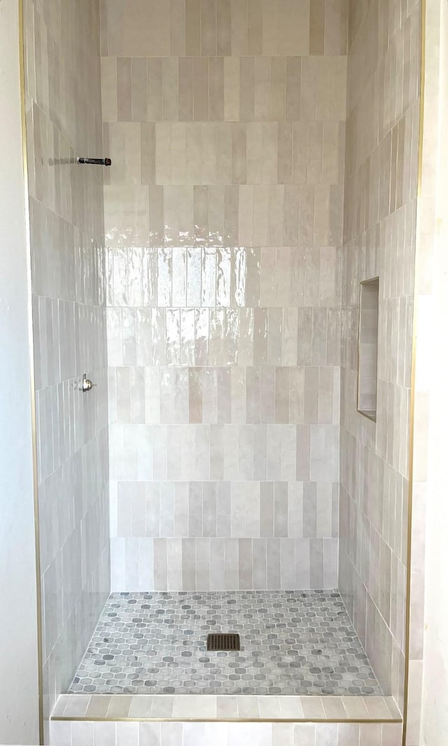 bathroom with a tile shower