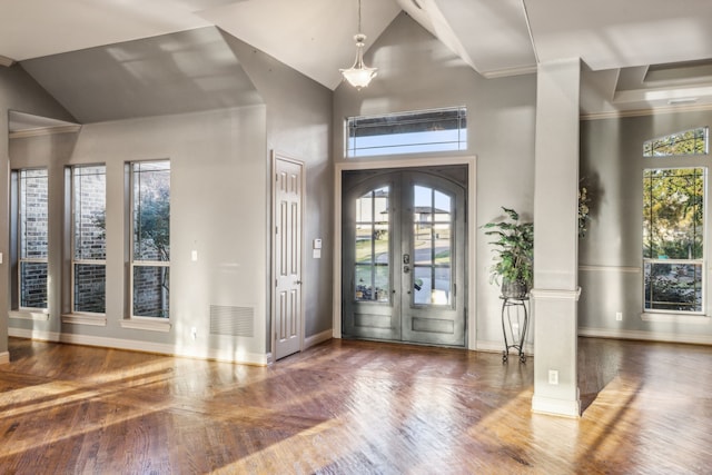 foyer featuring ornamental molding, dark wood-type flooring, high vaulted ceiling, and french doors