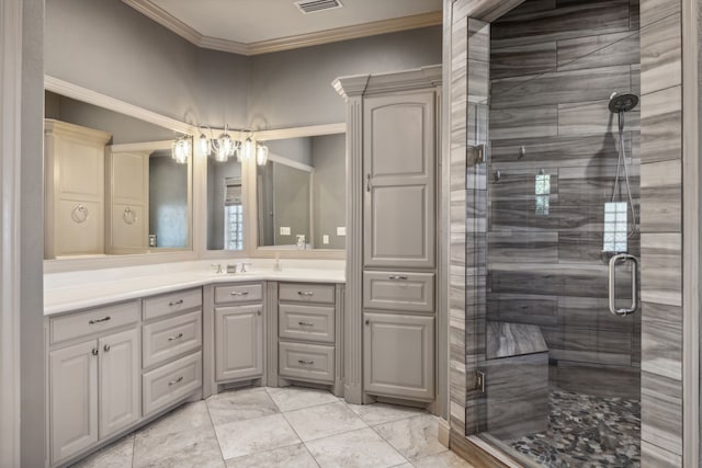 bathroom with vanity, a shower with shower door, and ornamental molding