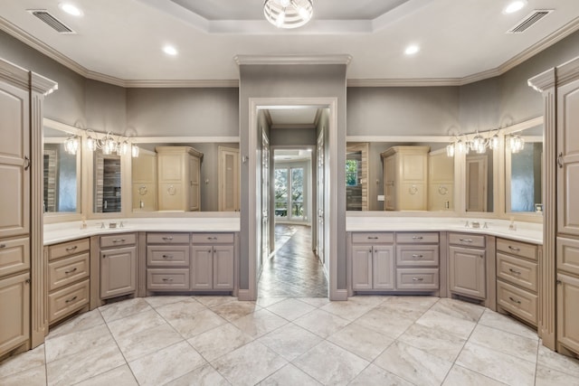 bathroom with vanity, crown molding, and a raised ceiling