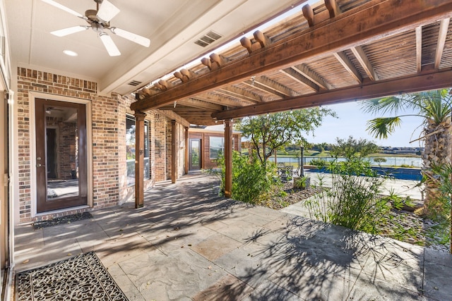 view of patio / terrace featuring ceiling fan and a water view